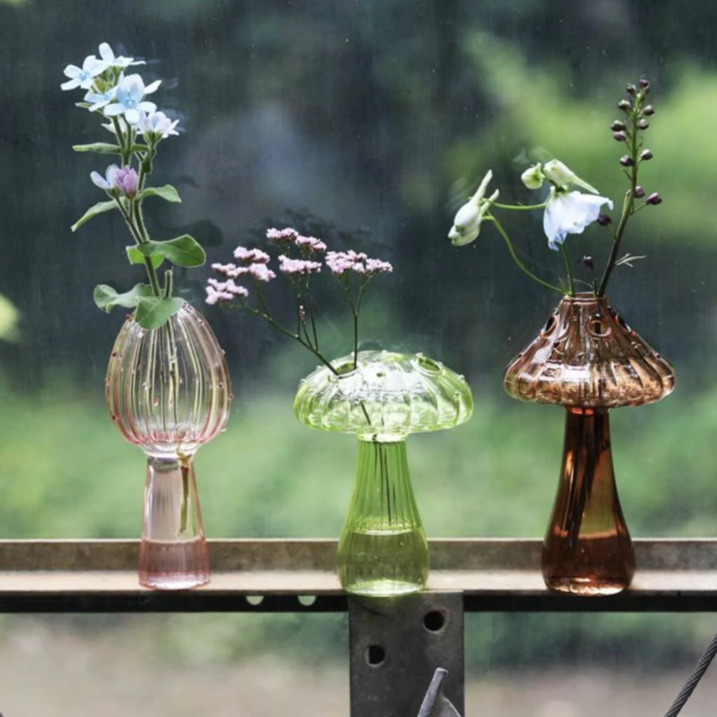 small glass vases in the shape of mushrooms