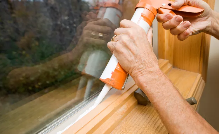 Start from one end and make a bead between the window trim and the window sill with silicone