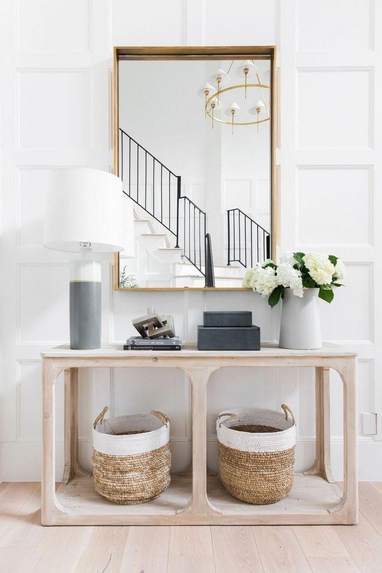 Hallway design in vintage style table and mirror and rattan baskets