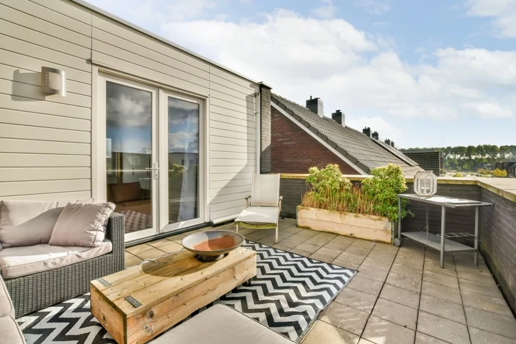 Relaxing roof terrace with patterned carpet