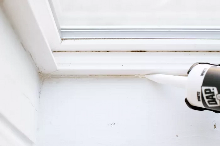 Apply silicone caulk to gaps or cracks on the window frame using a caulking gun