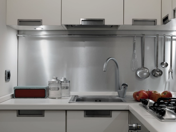 Subtly lit small cooking area with modern kitchen cabinets as a practical solution